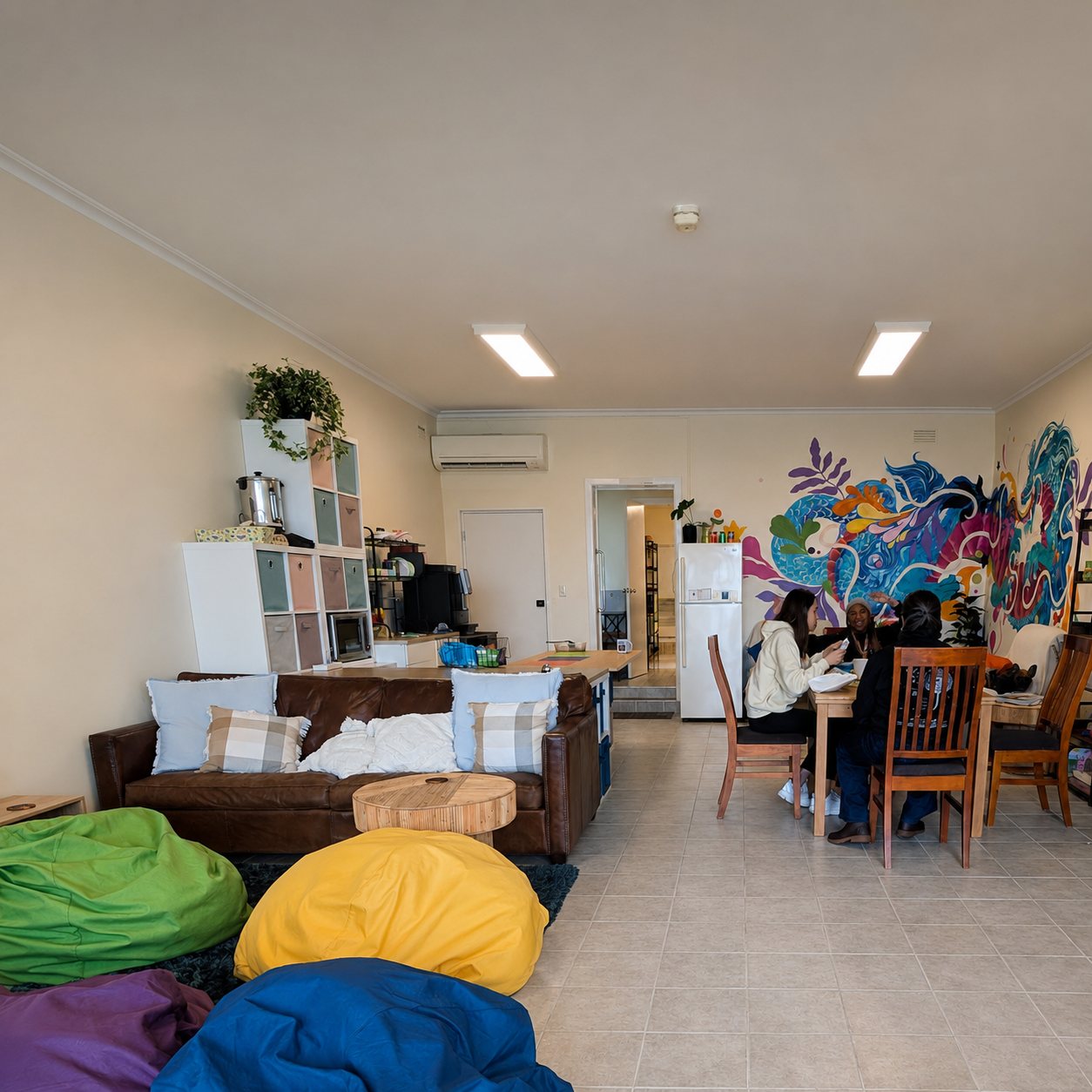 The main L.A.B. lounge — beanbags, a leather couch, a kitchen area and a colourful dragon mural on the wall.